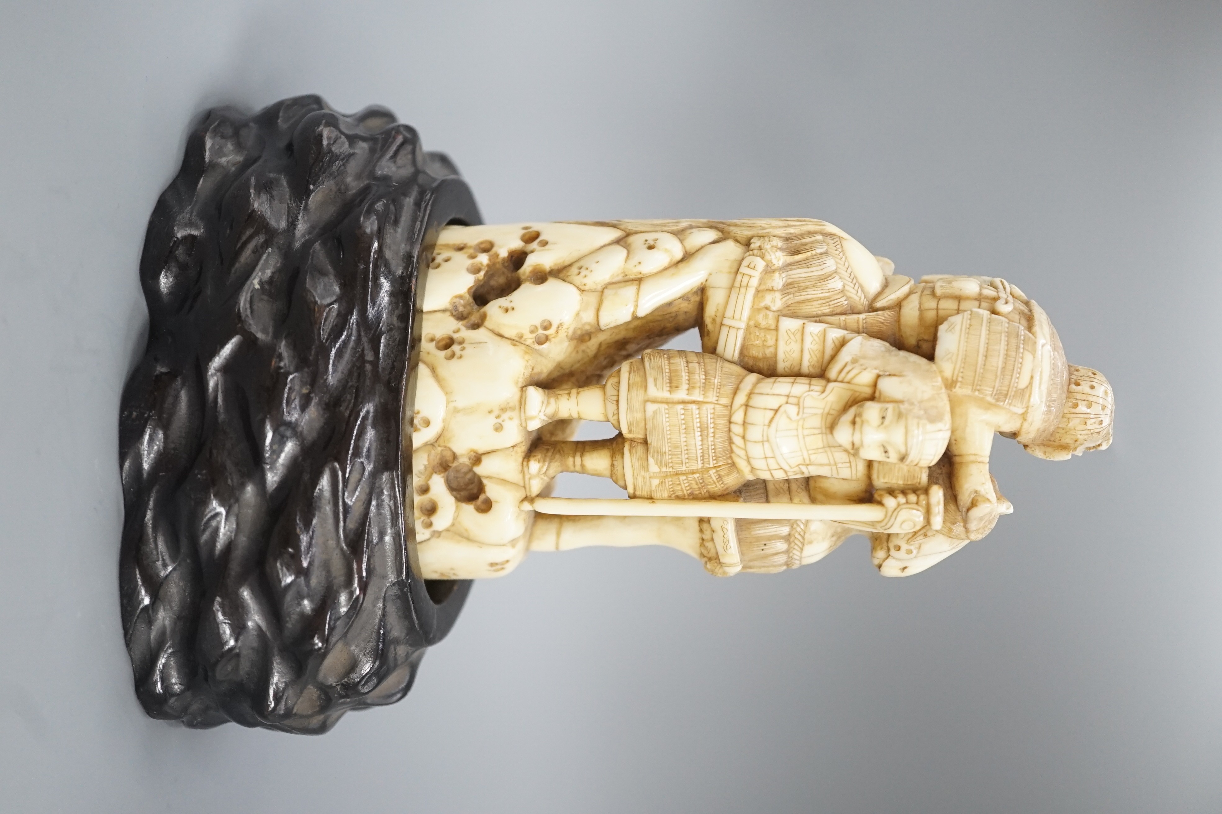 A Japanese ivory okimono of a samurai on horseback, with an attendant behind him, signed, late 19th century 12cm